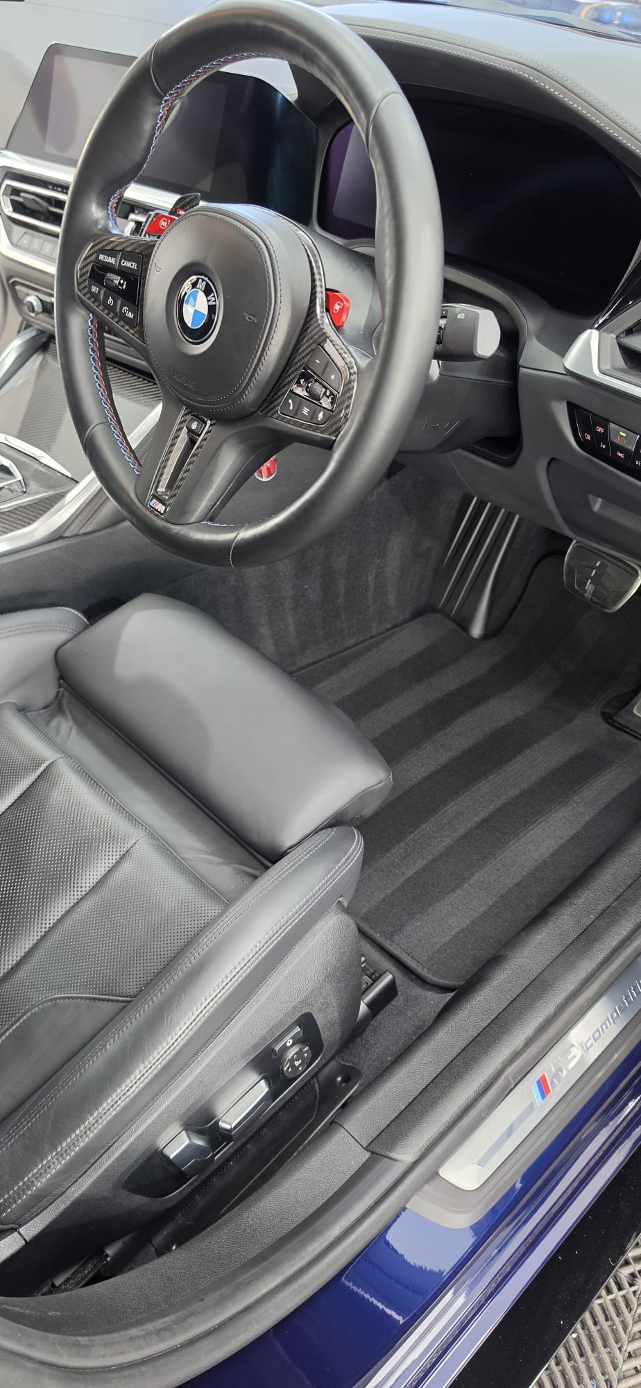 Spotless BMW M interior with clean leather seats and freshly vacuumed mats
