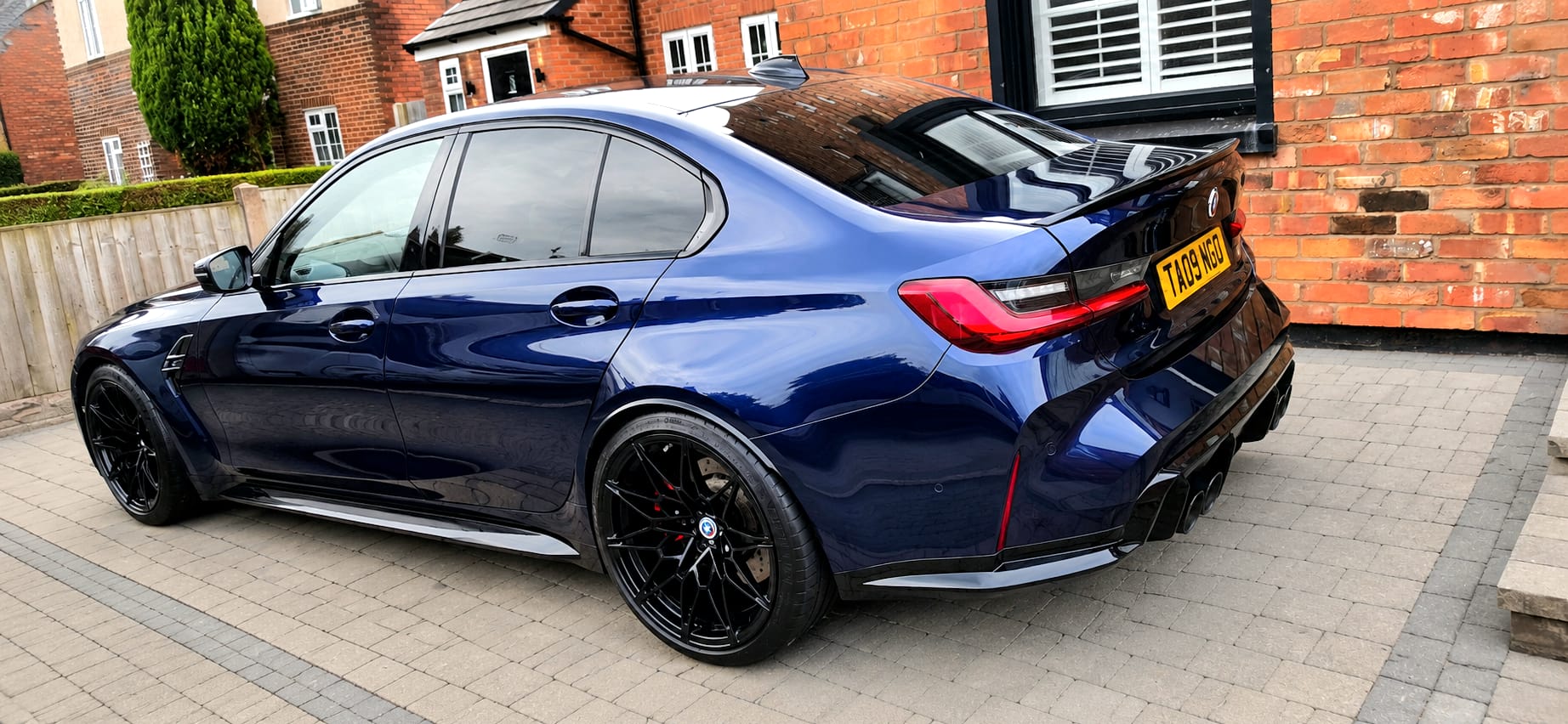 Deep blue BMW M3 Competition detailed to a mirror finish on a driveway